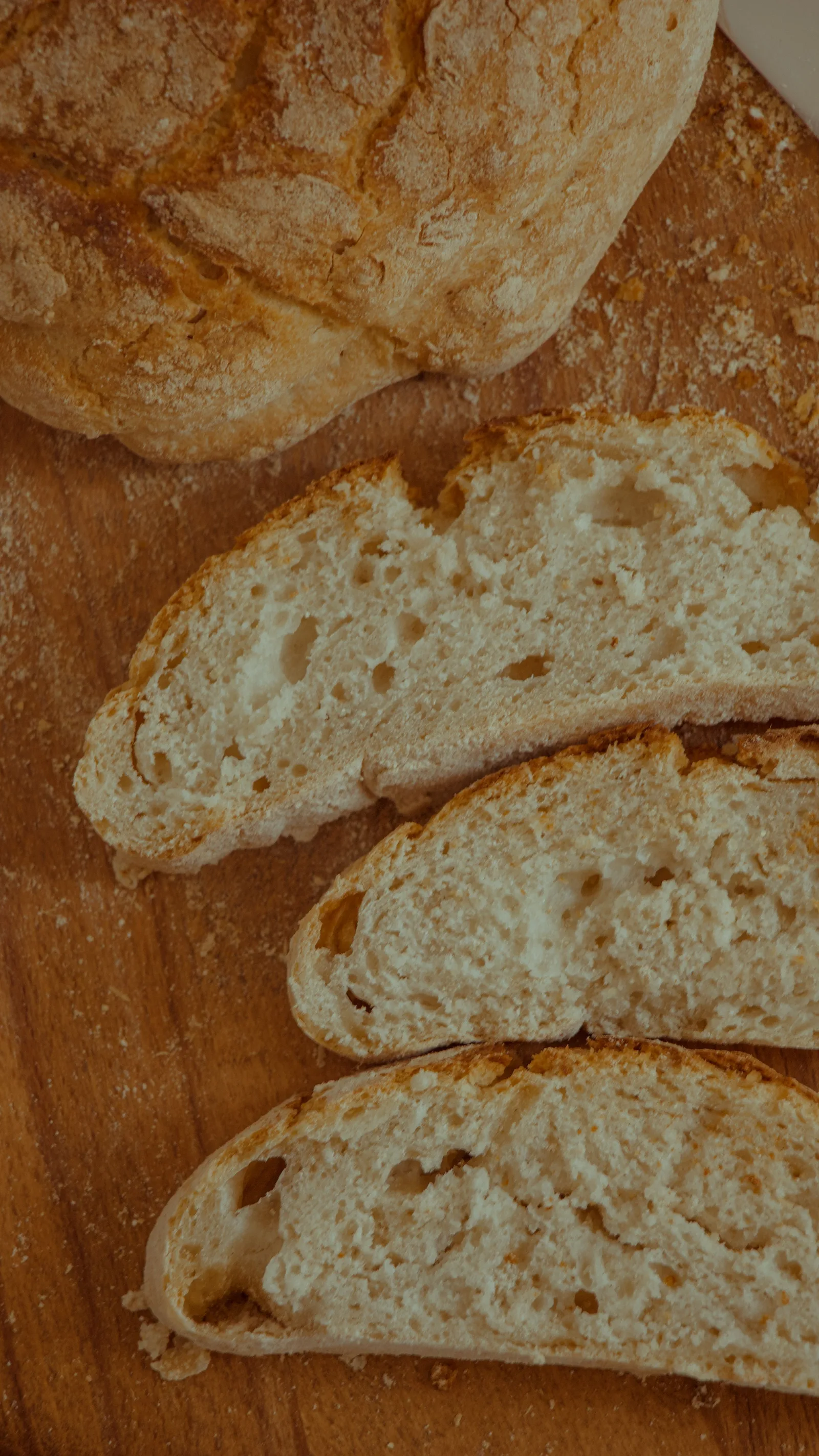 Thick slices of golden-crusted bread showing their airy, pale interior.